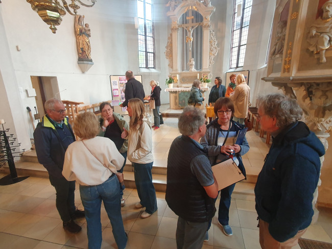 Menschen stehen in kleinen Gruppen im Kirchenraum der Seekapelle Bad Windsheim
